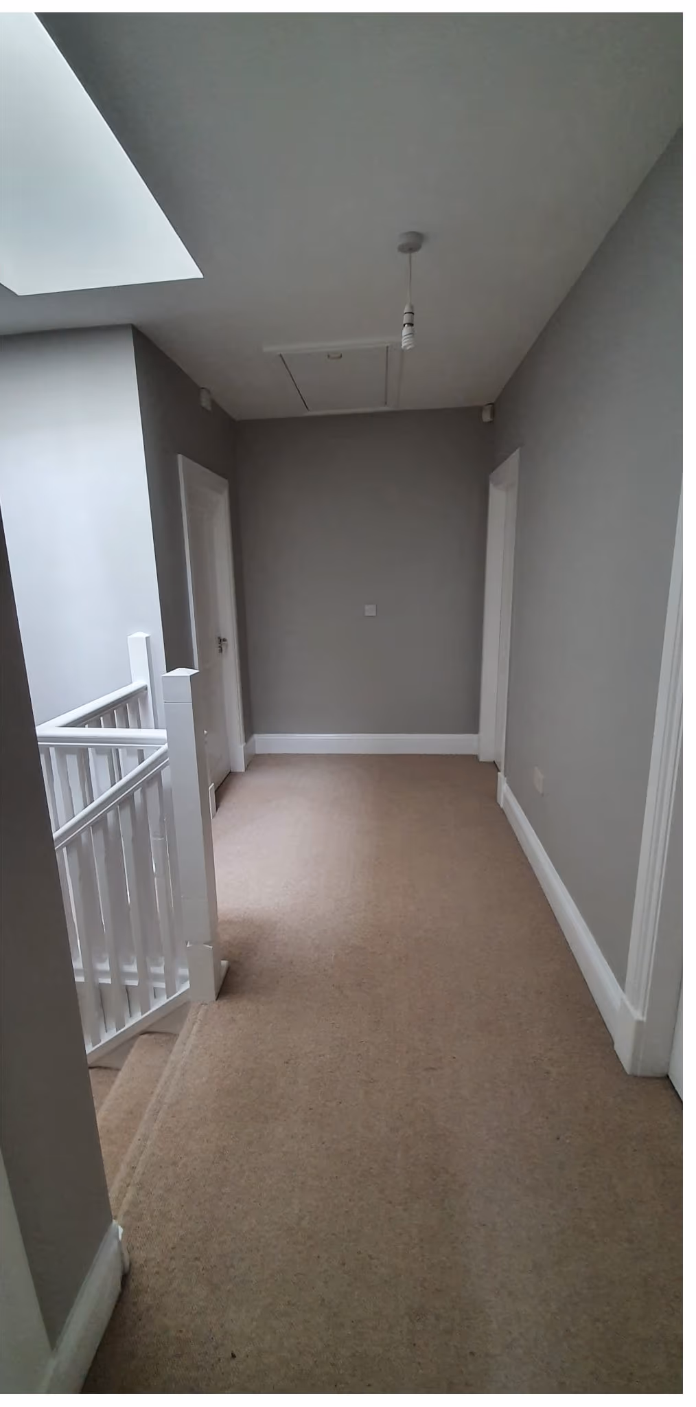 First-floor landing repainted in a bright neutral grey in Dublin