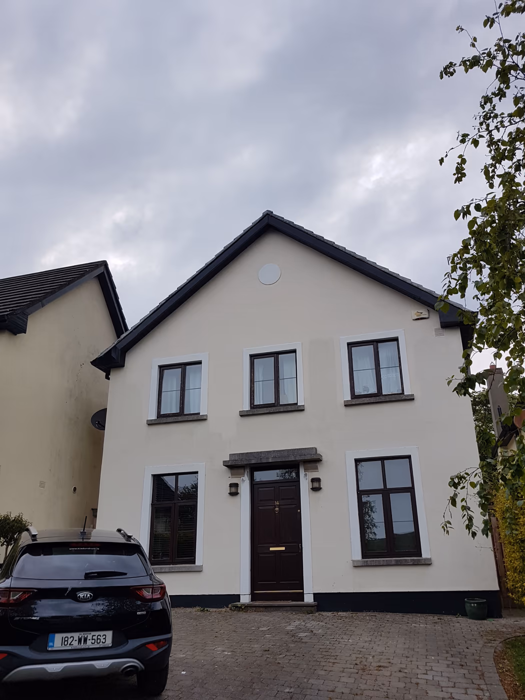 White-rendered detached house exterior painted in Dublin