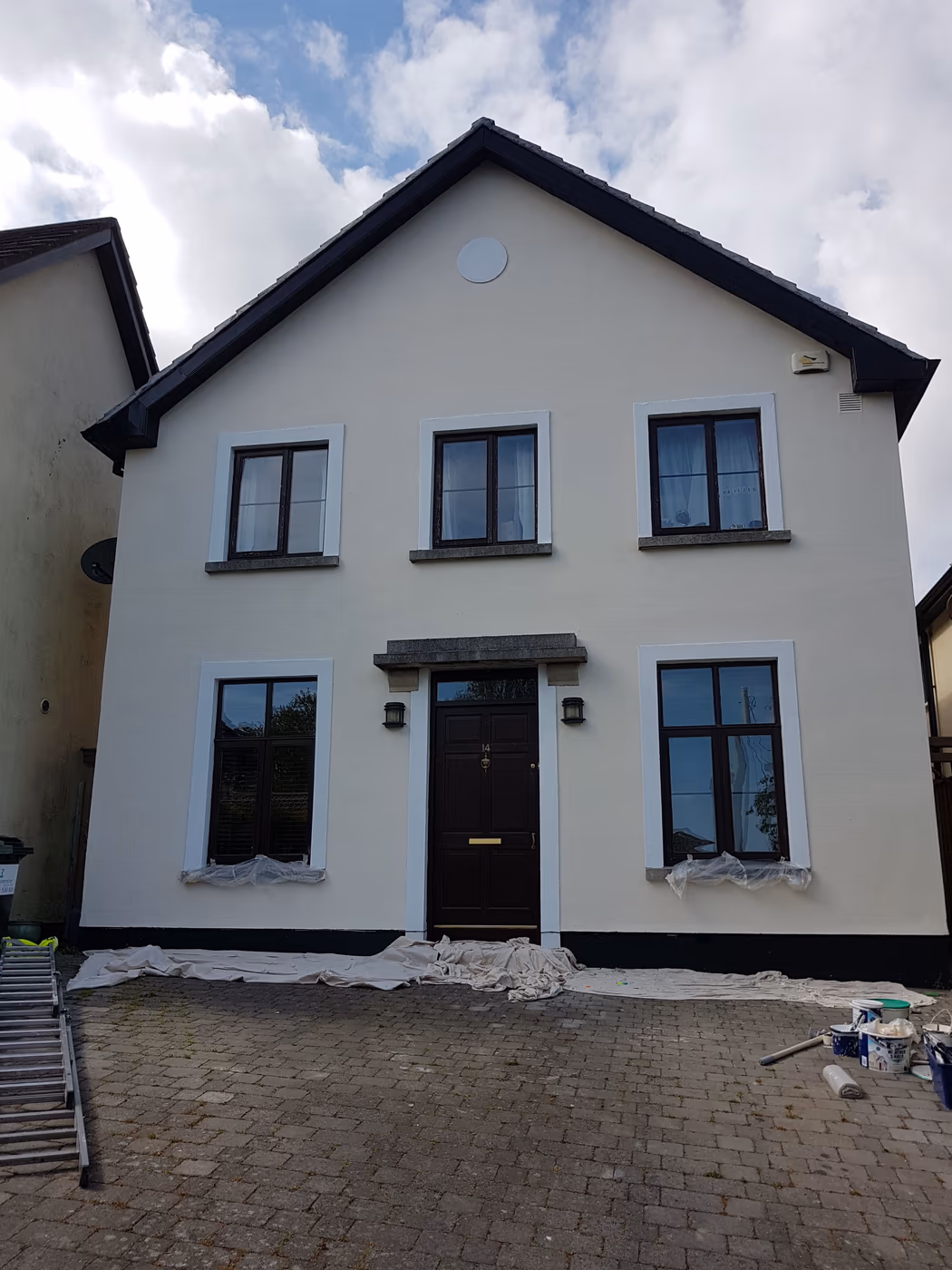 Freshly repainted white house exterior with a black front door in Dublin