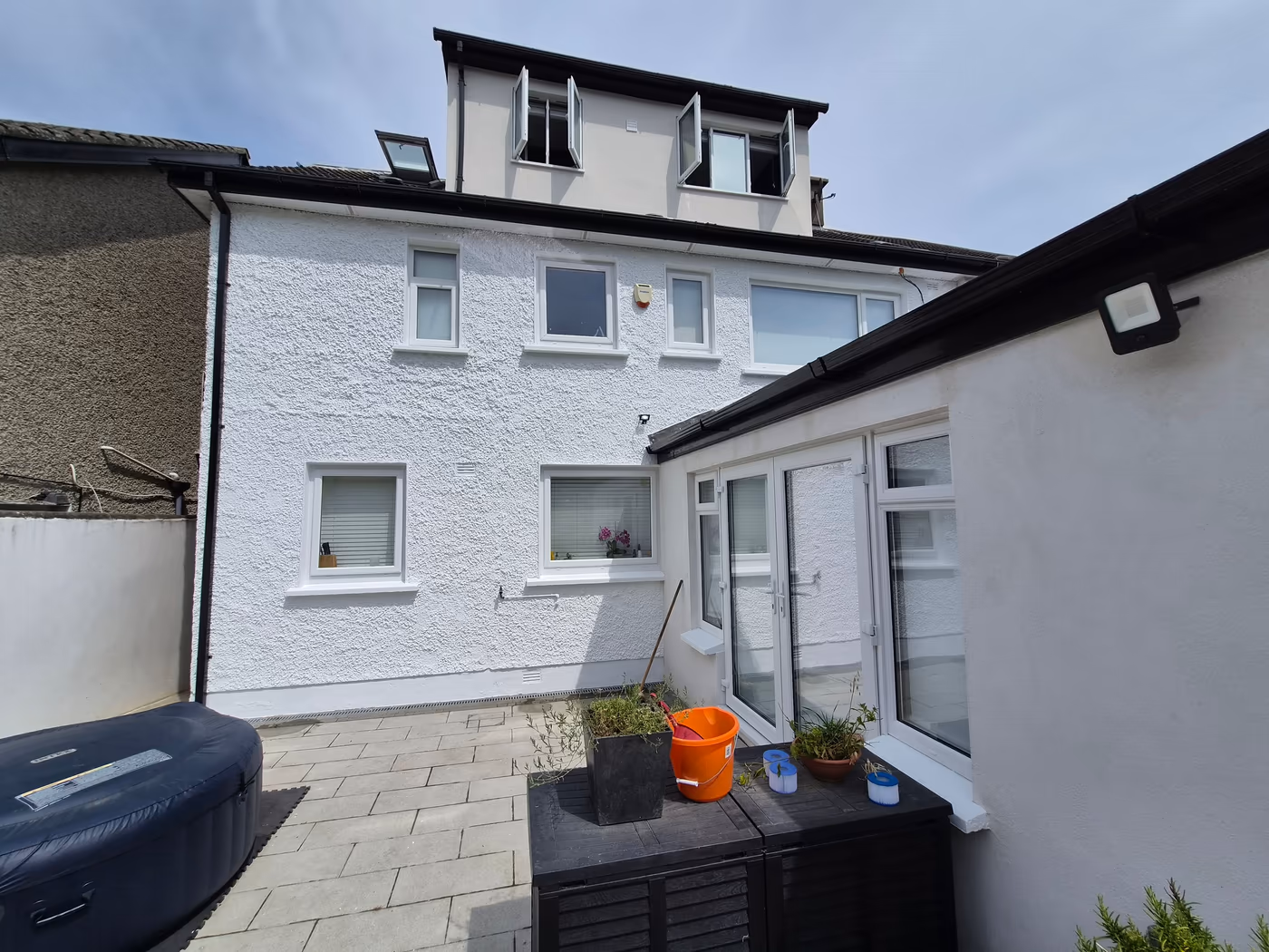 Freshly painted white-rendered house exterior with a patio in Dublin