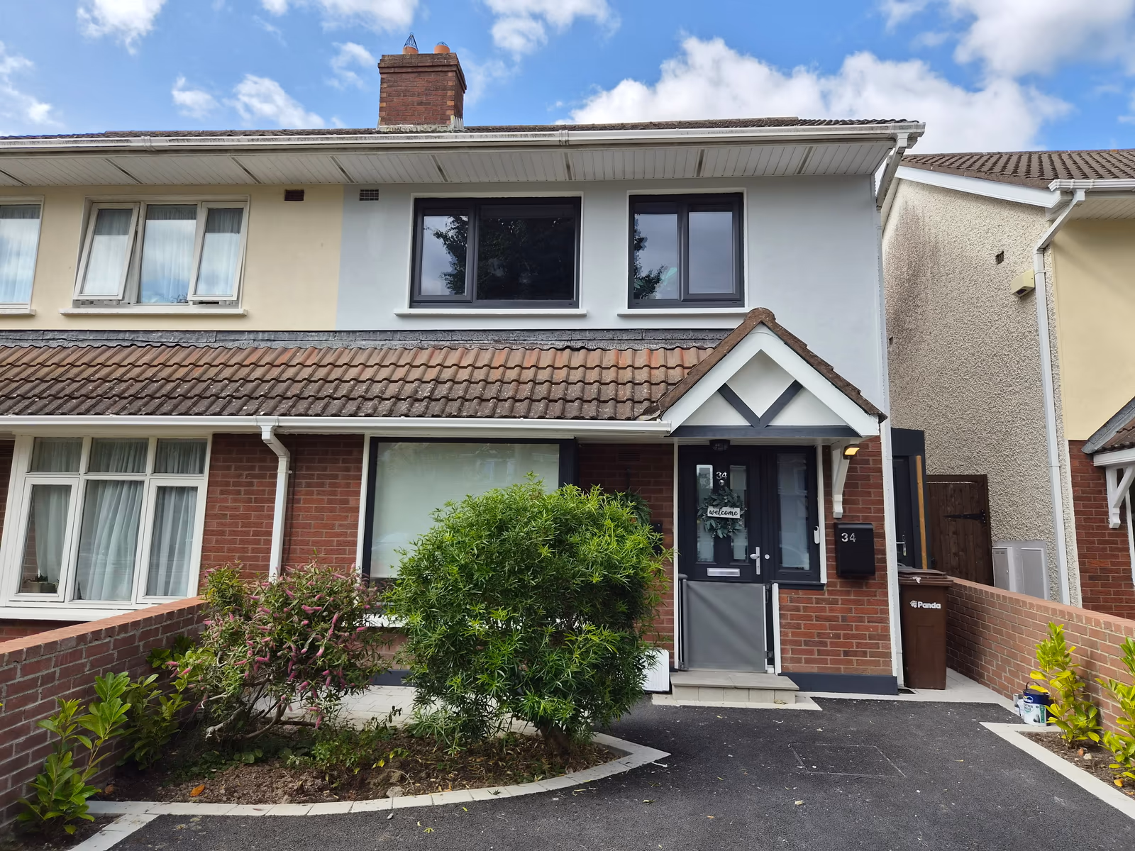 Freshly repainted brick and white semi-detached house exterior in Dublin