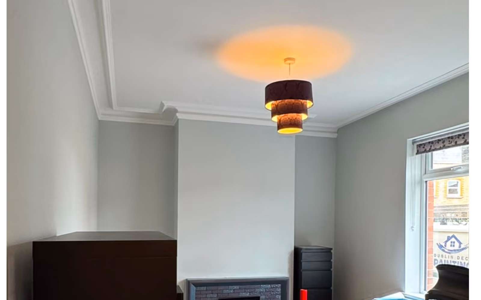 Freshly painted living room with a feature pendant light in a Dublin home